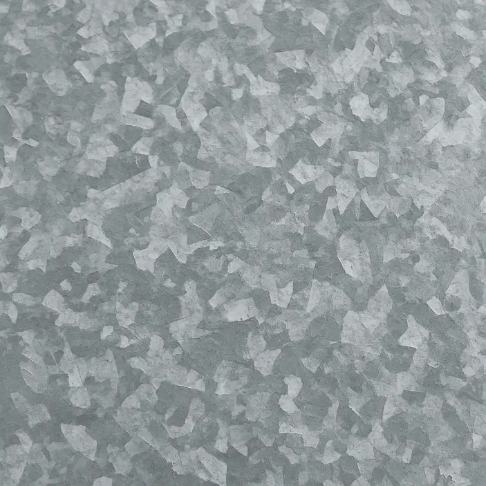 Macro photo of a galvanized steel surface, clearly showing the crystalline spangle pattern of the zinc coating with various shades of gray and a mottled texture.